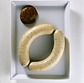A pair of Weisswurst (Bavarian sausages) and sweet mustard