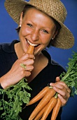 A Woman Eating Fresh Carrots