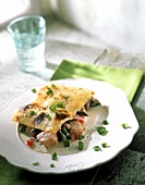 Gorgonzola & salmon lasagne with asparagus & tomatoes on plate