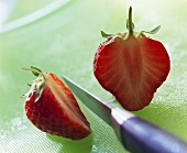 A Strawberry Cut in Half; Knife