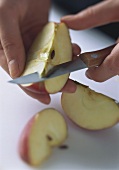 A piece of apple being cored