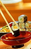 Maki-Sushi with Dipping Sauce in Red Bowl