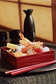 Zutaten für Chiqasmi-Sushi in Roter Kiste, daneben Stäbchen