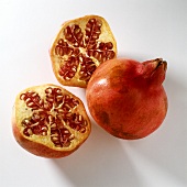 Whole and halved pomegranate