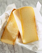 Two pieces of cheese: Fontina and Formai de Mut