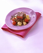 Fillet steaks on gnocchi with rosemary & cocktail tomatoes