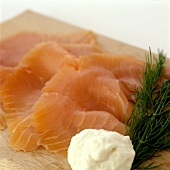 Smoked wild salmon with horseradish & dill on wooden board