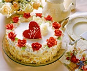 White cream gateau with red marzipan roses for Mother's Day