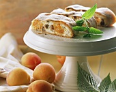 Curd cheese strudel with apricots on cake plate