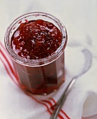 Plum jam in jar, decoration: spoon and sugar