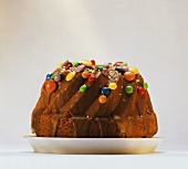 Gugelhupf with chocolate icing & coloured chocolate beans