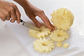 Removing the stalk from pineapple slices