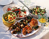 Table set for barbecue: grilled meat & dishes