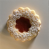 A jam biscuit against a white backdrop