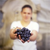 Young Woman Holding Grapes