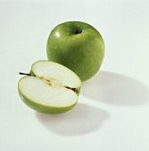 One half and one whole Granny Smith apple