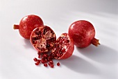 Pomegranates, whole and halved