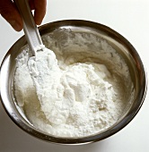 Mixing grated coconut with cream
