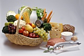 Basket of foodstuffs, fish, veal etc beside it