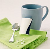 Sweetening tablets with cup and spoon