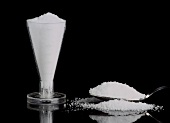 Sweetener in measuring jug and on spoon