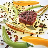 Raw beef steak in pepper marinade with capers & chillies