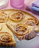 Lemon tart, pieces cut, one piece on cake slice