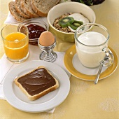 Breakfast: bread & nut-nougat spread, juice, milk, egg, muesli