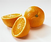 One halved and one whole orange