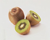 Whole and halved kiwi fruit