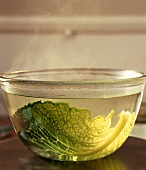 Savoy leaf in a bowl with steaming water