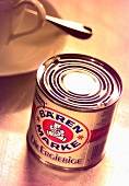 A tin of Bärenmarke coffee cream in front of a coffee cup