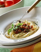 Pasta alla puttanesca (pasta with olive and caper sauce)