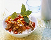 Duck with pineapple, peppers and rice in bowl