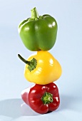Red, yellow and green peppers, on top of each other