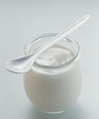A jar of natural yoghurt with spoon