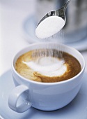 Putting sugar in cappuccino