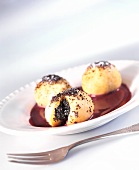 Poppy seed dumplings with blueberry sauce