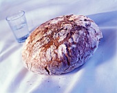 A loaf of bread and a glass of water
