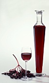 Elderberry liqueur in glass and bottle