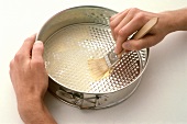 Greasing a baking tin