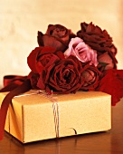 A wrapped present and red roses