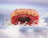 Raw tuna stuffed with plums, with bonito flakes