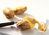 Peeling potatoes with a potato peeler