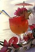 Planter's punch with slice of carambola & flower decoration