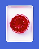Turned-out raspberry jelly on rectangular dish