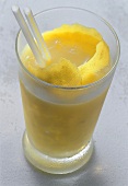 Mango cocktail with lemon peel