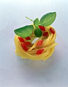 A spaghetti nest with diced tomatoes and basil