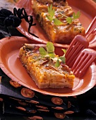 Savoury pumpkin tray-bake on party plates for Halloween