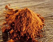 Ground paprika on a brown background